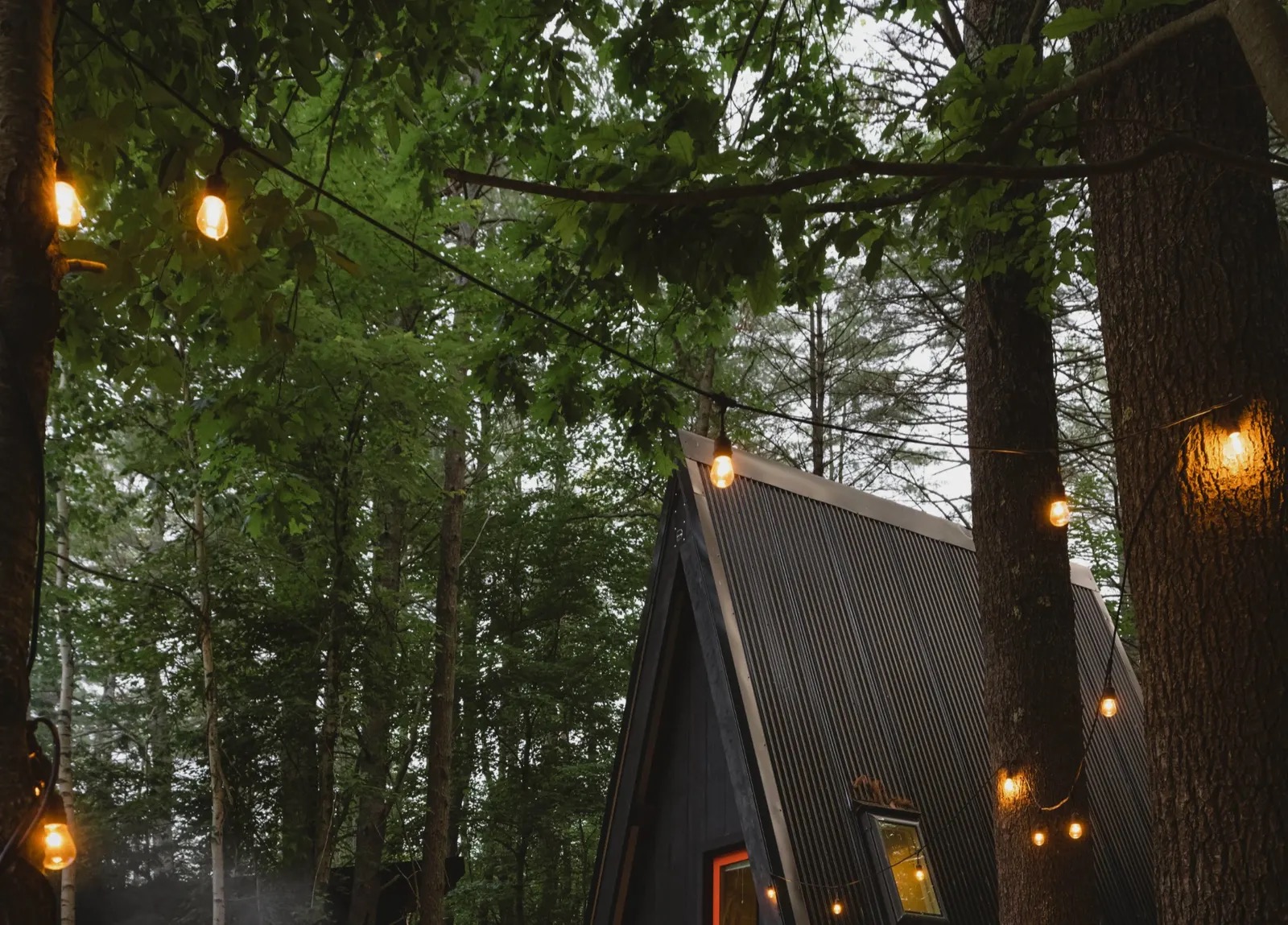 String lights glowing over the campground at night