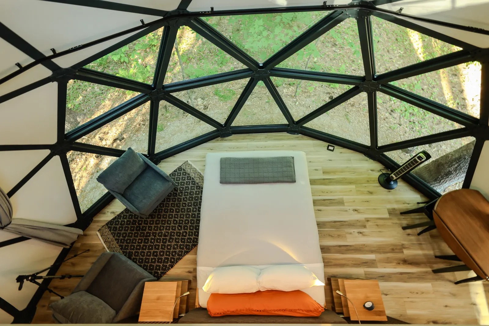 Inside a Luna dome: a queen bed under 13-foot ceilings and a giant window