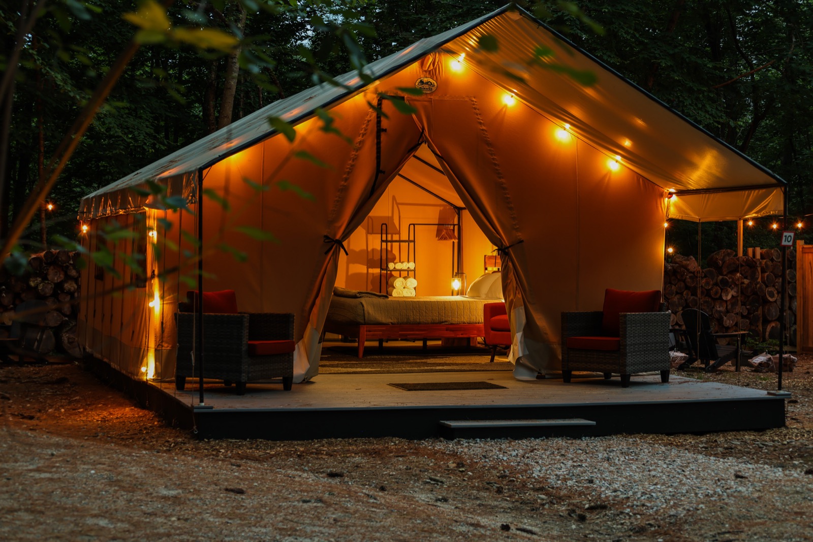 A Luxe glamping tent lit up at night